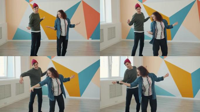 年轻女子在现代艺术工作室教帅哥跳舞动作