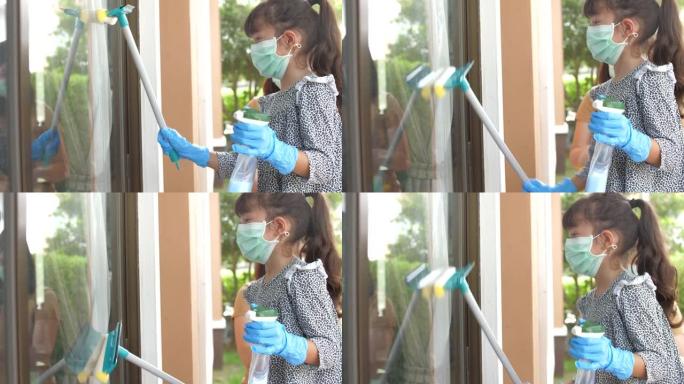 小女孩在母亲的帮助下清洁窗户玻璃