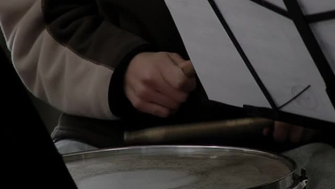一个男生在学校的音乐课上打鼓。特写。