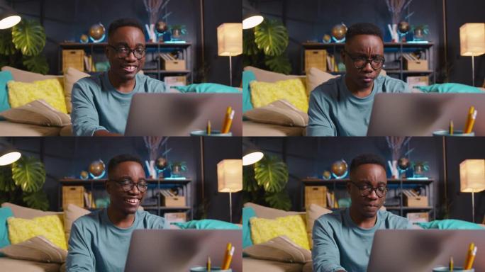 年轻快乐的gen-z黑人男生戴眼镜，用笔记本电脑在舒适的家中在线学习表达各种情感。