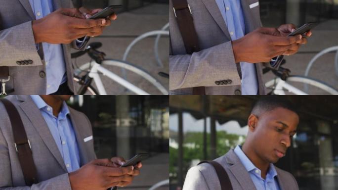 非裔美国商人在现代办公楼外使用智能手机