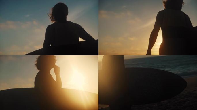 男人看着大海，在日落时分将冲浪板放在手臂下，剪影