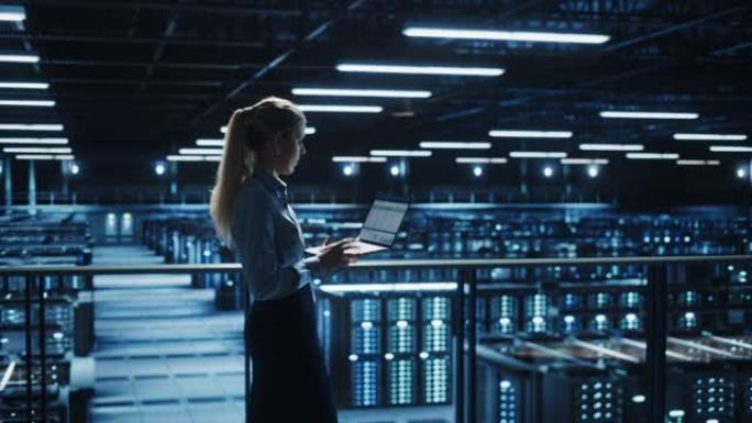 数据中心女性IT专家使用笔记本电脑。信息技术工程师负责监督和浏览云计算服务器场维护和监控。轮廓中等镜