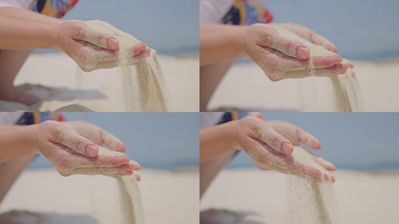 在凉爽的夏日微风中，无法辨认的女人的手穿过异国情调的海滩