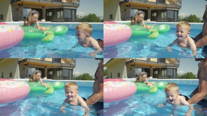 特写: 年轻的家庭在后院游泳池里玩耍，而小男孩试图游泳