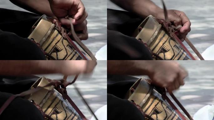 一名男子恢复了用木头和动物皮革制成的阿根廷鼓 “Bombo Leguero”，用于当地传统民俗音乐。