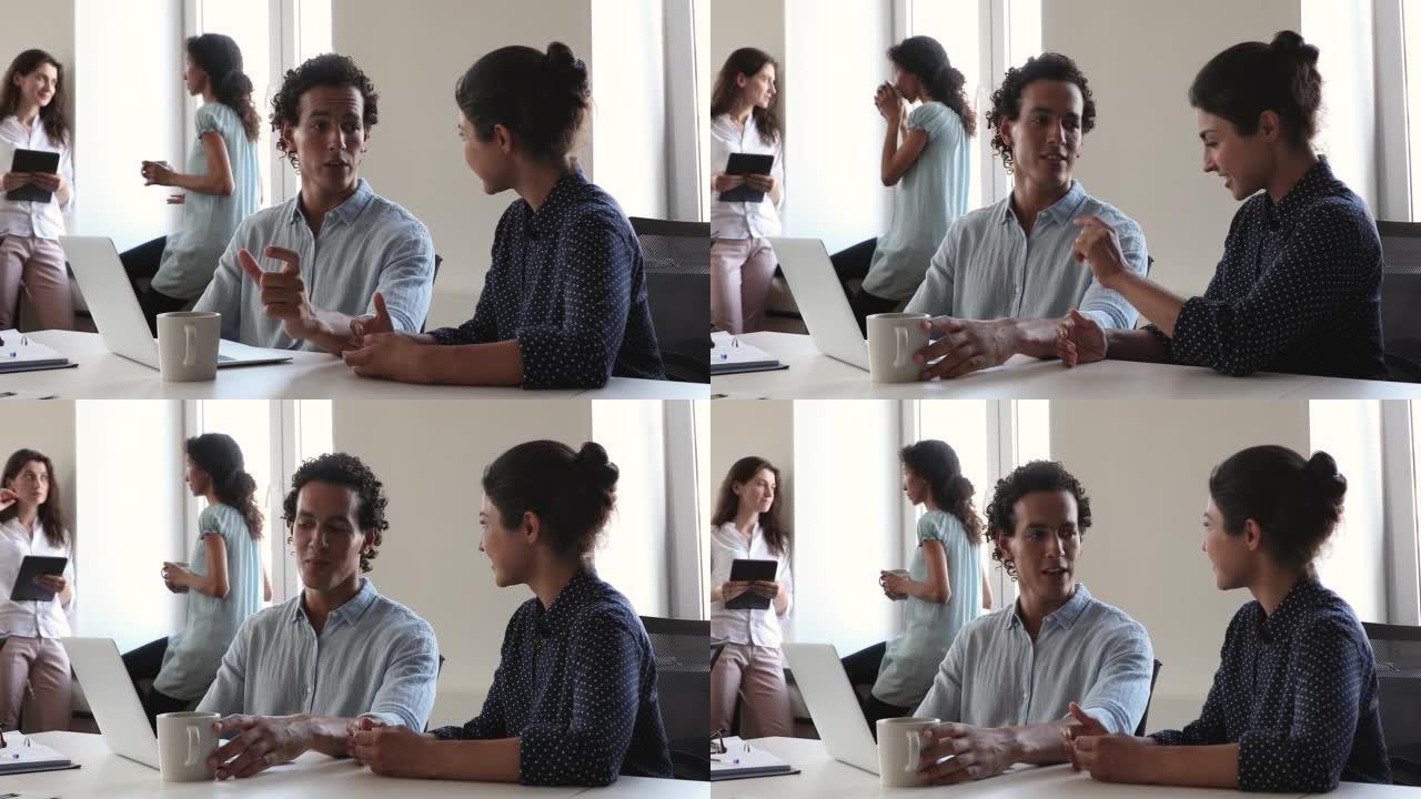 西班牙裔男性导师向年轻的印度女士新手解释工作