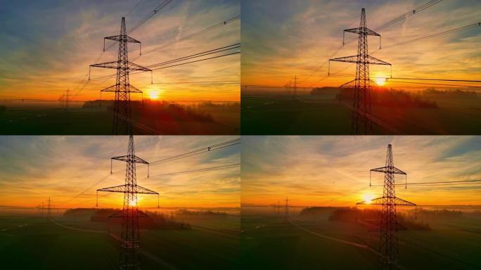 日落时乡村上空的电塔和电线
