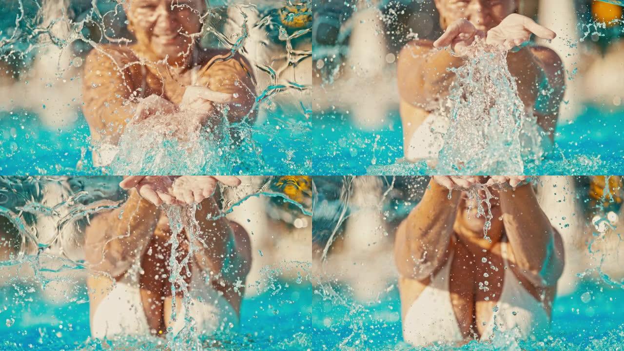 超级SLO MO女人在游泳池里用手舀水