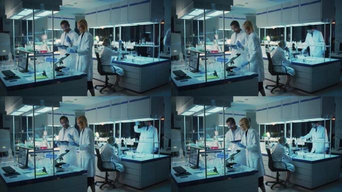 女性和男性医学研究科学家在样品试管中进行实验时进行了交谈，在平板电脑上写下了分析结果。现代生物科学实