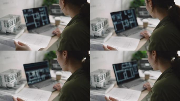建筑师女性建筑协调员在笔记本电脑上检查建筑计划