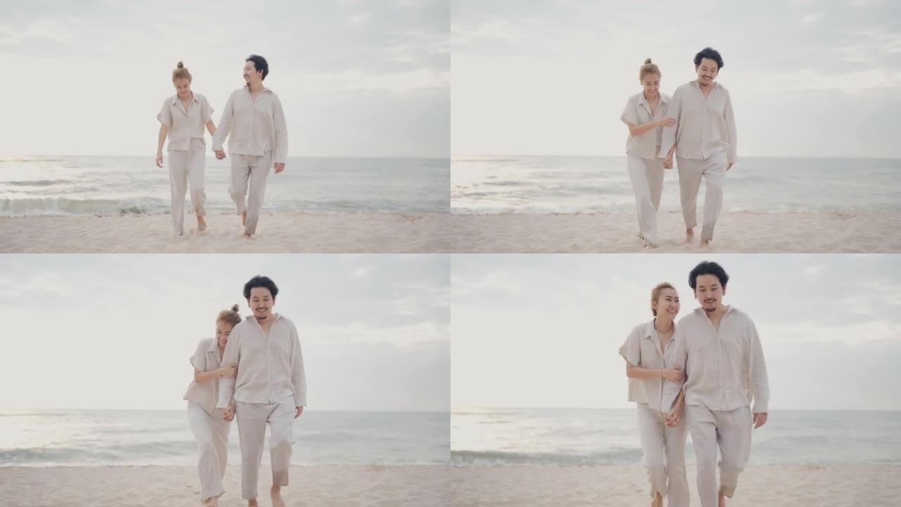 夫妇在海边度假享受生活漫步沙滩