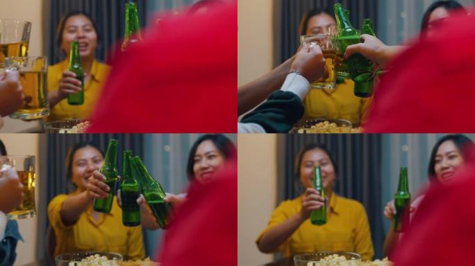 一群多民族的亚洲成年朋友的特写镜头，他们喝酒精啤酒瓶玻璃，开心地笑，在夜生活室内享受聚会。