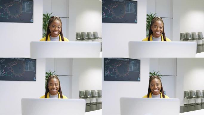 坐在笔记本电脑前的年轻非洲妇女的肖像