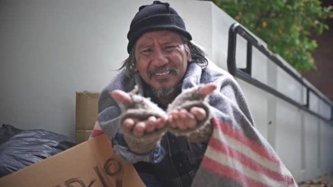 路人把钱给无家可归的乞丐