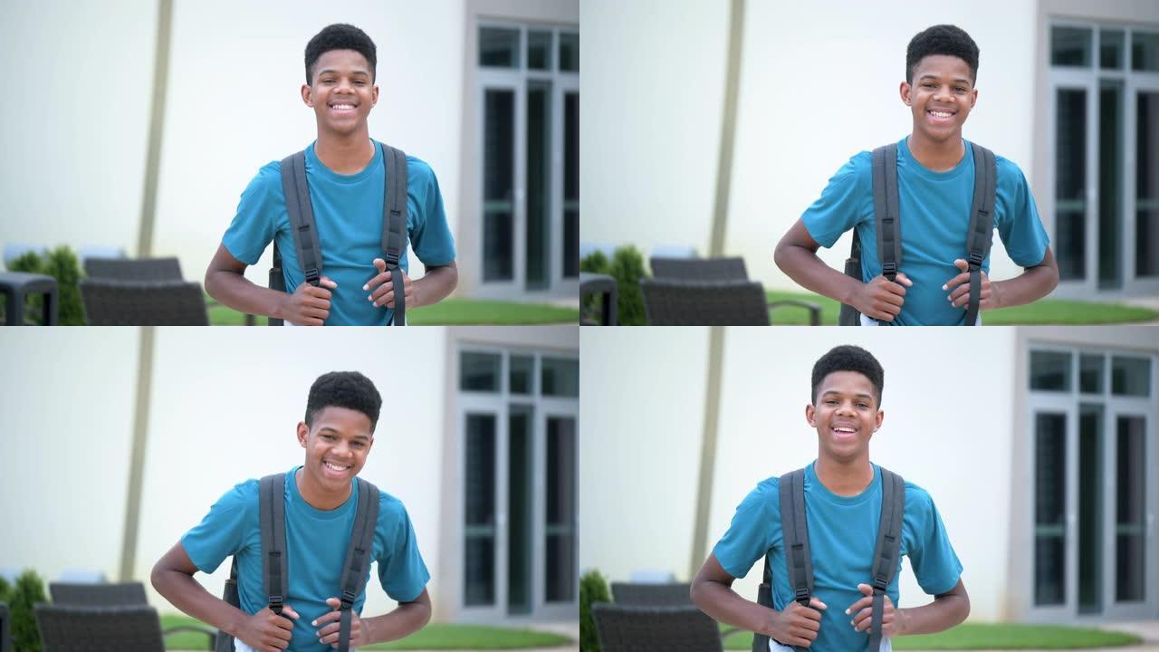 非裔美国少年站在学校外面