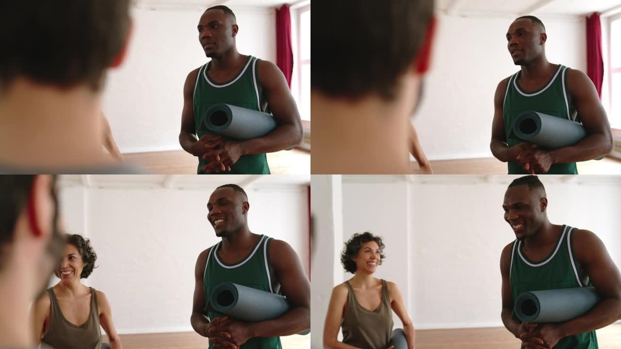 非洲男子在健身房与瑜伽课小组交谈