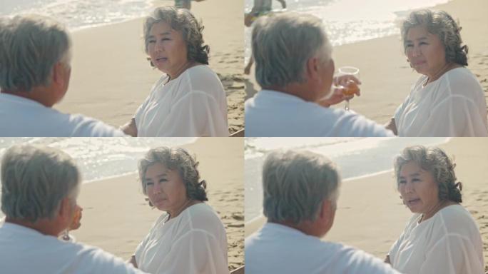 SLO MO成熟夫妇在海滩上喝酒
