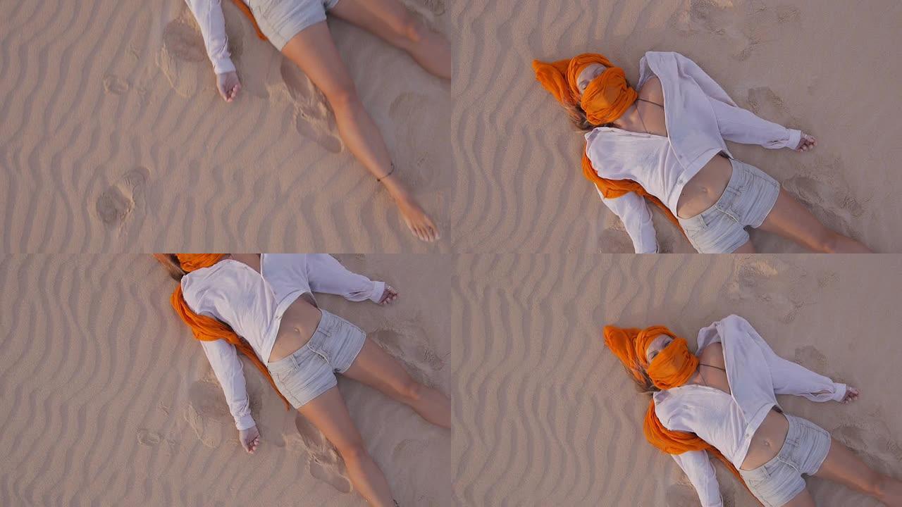 空中: 女人躺在沙漠中