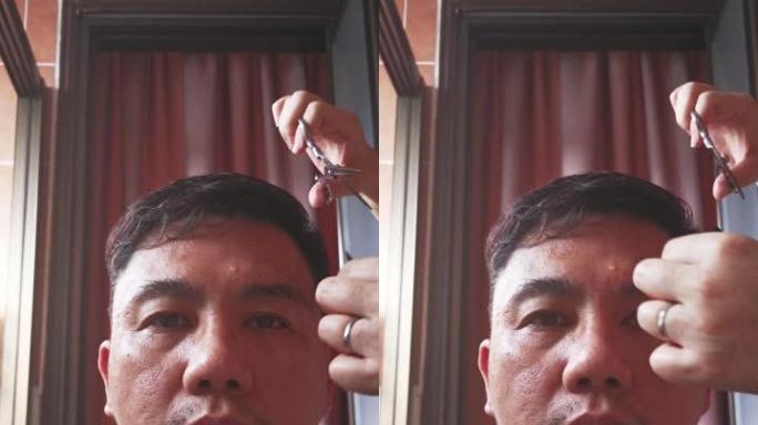 亚洲中国中年男子在家由妻子理发