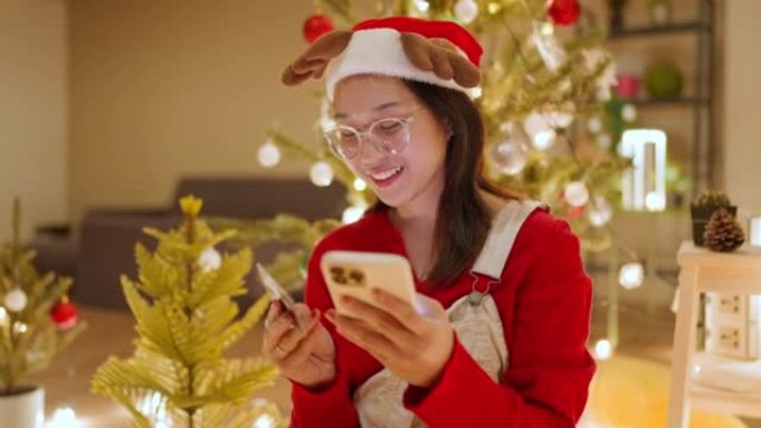 年轻女子在网上购物购买圣诞礼物。