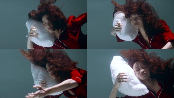 电影特写，年轻漂亮的混血女人穿着红色睡衣沉入水下，头在枕头上慢动作。