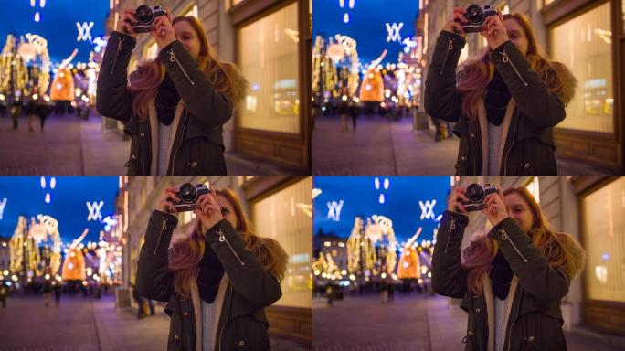 美丽的女人在城市中探索圣诞节，欣赏灯火通明的装饰街道
