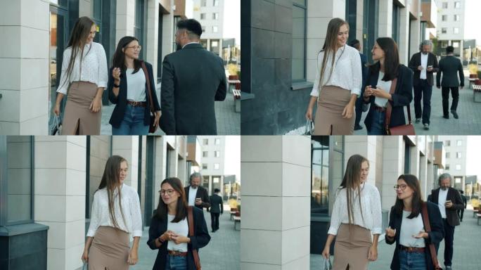 穿着正式服装的开朗年轻女士的慢动作在人行道上向男同事打招呼