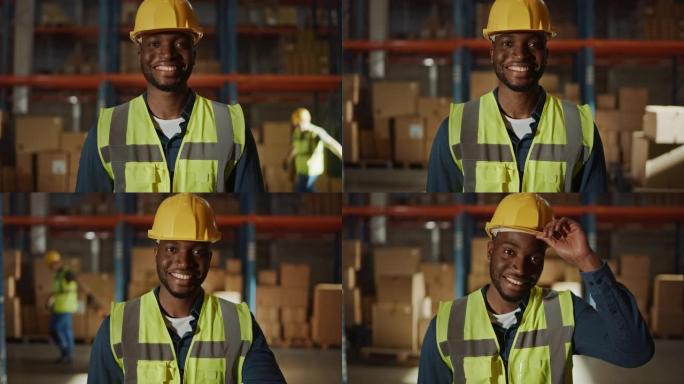 穿着安全背心和安全帽的英俊快乐的职业工人在镜头前迷人地微笑。在后台的大仓库里，货架上堆满了送货货物。