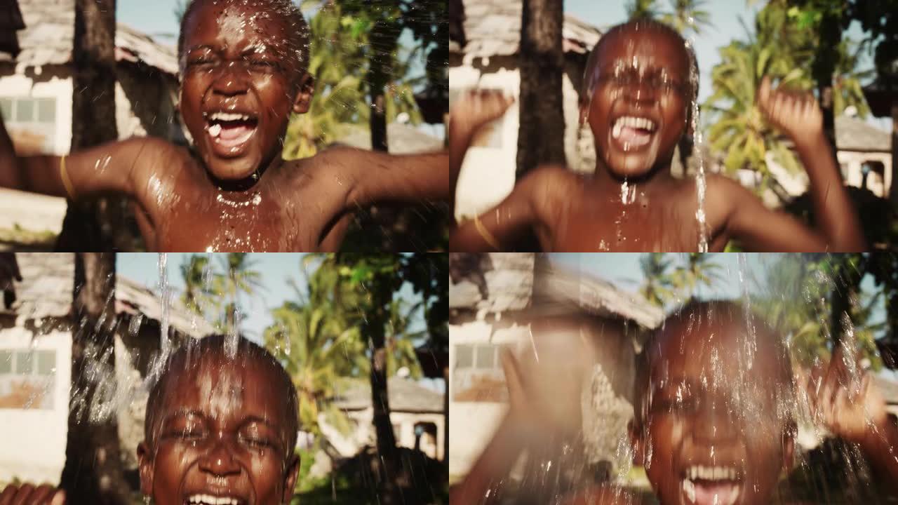 一个非洲小男孩在倾盆大雨下蹦蹦跳跳的肖像。在漫长的干旱和炎热的天气后，快乐而天真的黑人孩子们玩耍和享