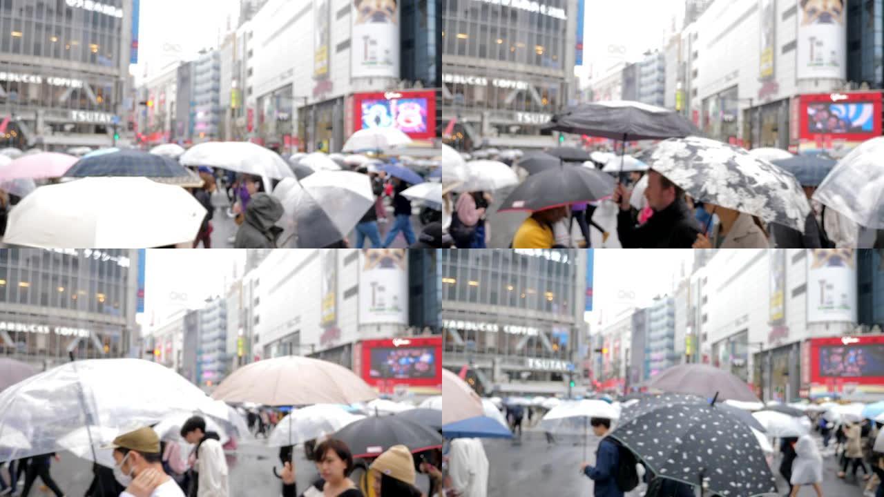 涩谷十字路口雨中带伞的通勤者
