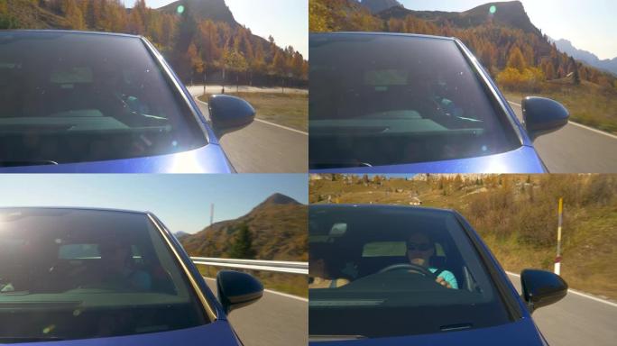 特写: 男子开车送女友沿着多洛米蒂山脉的风景秀丽的山路。