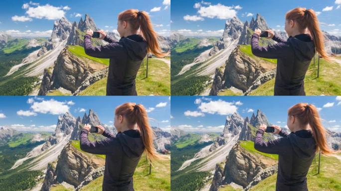 意大利多洛米蒂塞塞达山上的女旅行者，拍摄令人叹为观止的景色