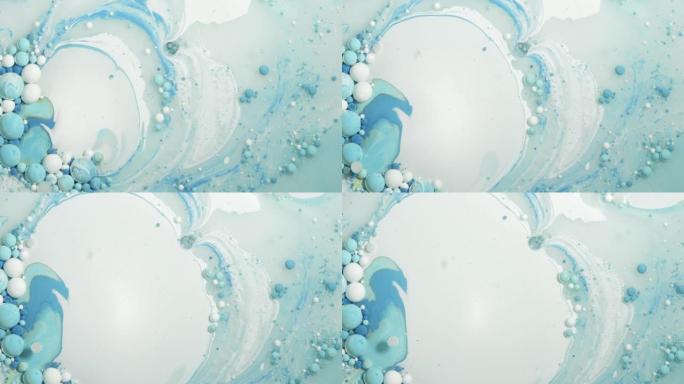 多色丙烯酸涂料气泡在水中移动并爆炸