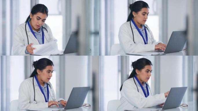 女医务人员，在办公室用笔记本电脑看书打字，为病人做医疗研究。医院文件和女医生忙于管理pc上的专业记录