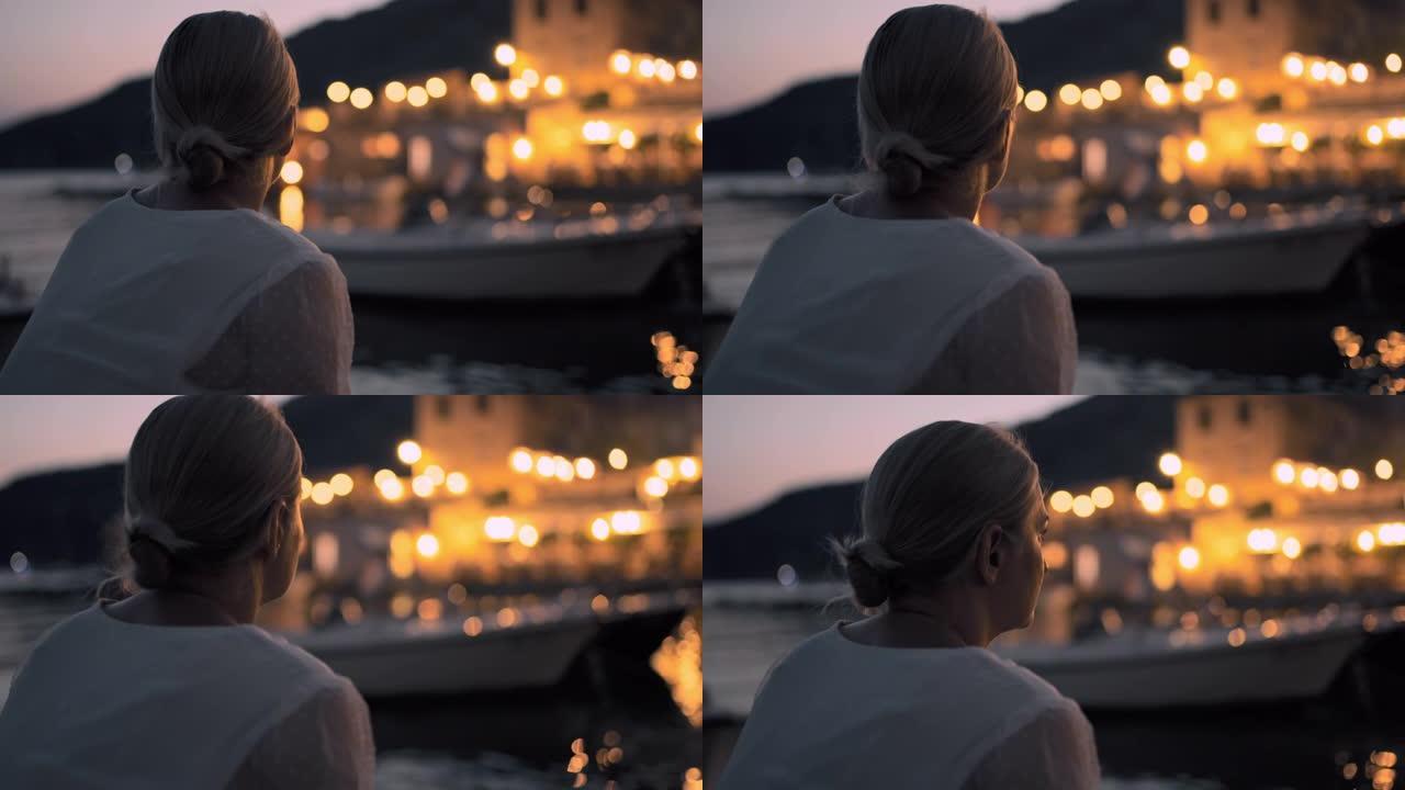 克罗地亚黄昏时，CU年轻女子在宁静的港口放松