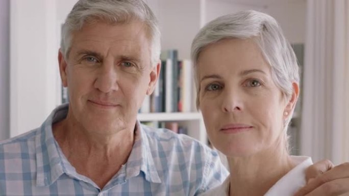肖像快乐的老夫妻微笑着享受退休生活，分享浪漫的周年纪念拥抱在家4k镜头