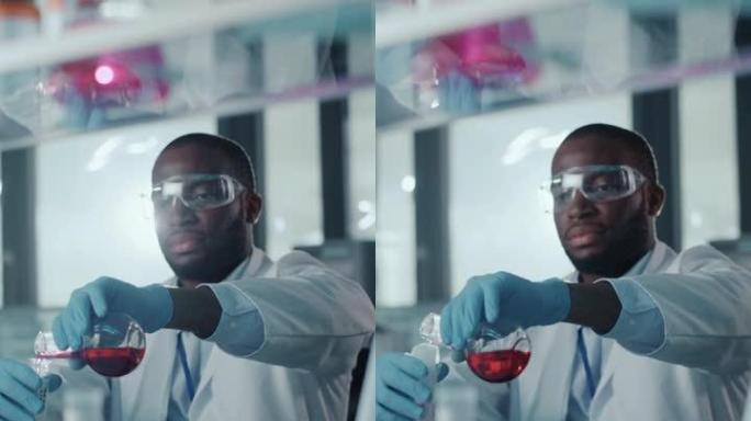一位非裔美国男性科学家在实验室的试管中混合化学物质的垂直肖像。英俊的黑人微生物学家在现代实验室工作，