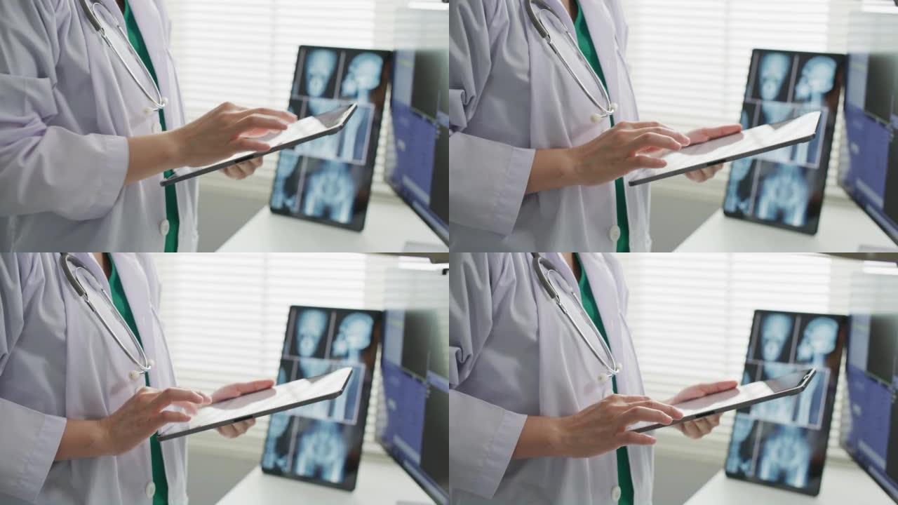 在医院办公室从事数字平板电脑工作的医生