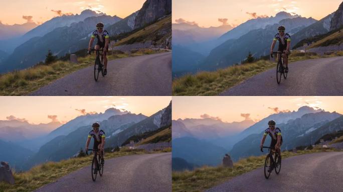 健康的男性公路自行车手骑自行车在黄昏的美好一天上坡风景秀丽的山路