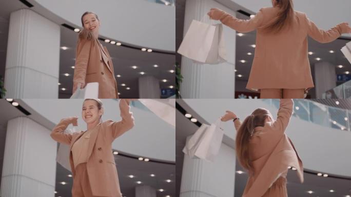 标题: 兴奋的女人带着购物袋在镜头前旋转