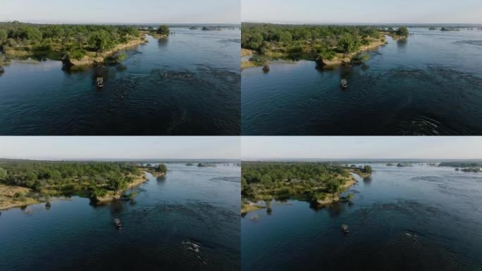在赞比西河上观光的旅游船的空中缩小视图