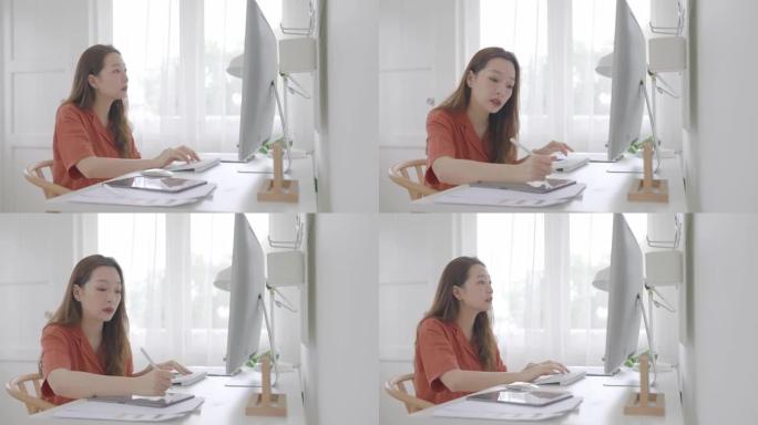 美丽的亚洲女商人年龄36岁在家工作的数字平板电脑与电脑。成人在线学习概念。与阿尔法香奈儿。