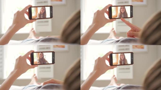 一个无法识别的女人使用智能手机进行视频通话的4k视频片段