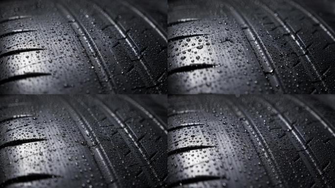 汽车轮胎滚动，全新街道轮胎上有水滴的胎面花纹