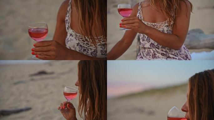 年轻女子女士在日落时在沙滩上喝玫瑰酒