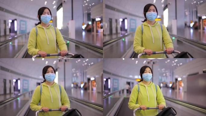 机场戴口罩的女人推着行李的女人视频素材