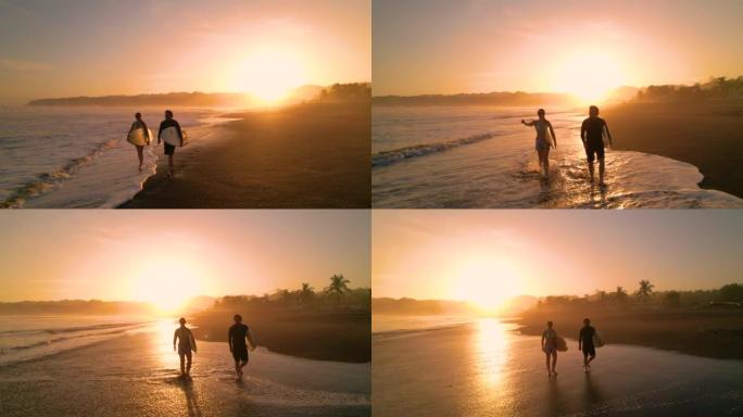 空中剪影: 日落冲浪后，冲浪情侣在沙滩上散步