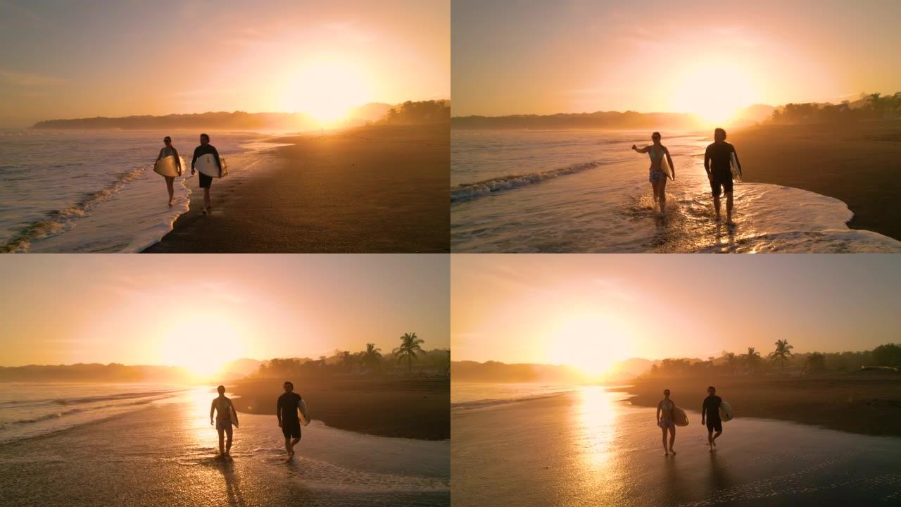 空中剪影: 日落冲浪后，冲浪情侣在沙滩上散步