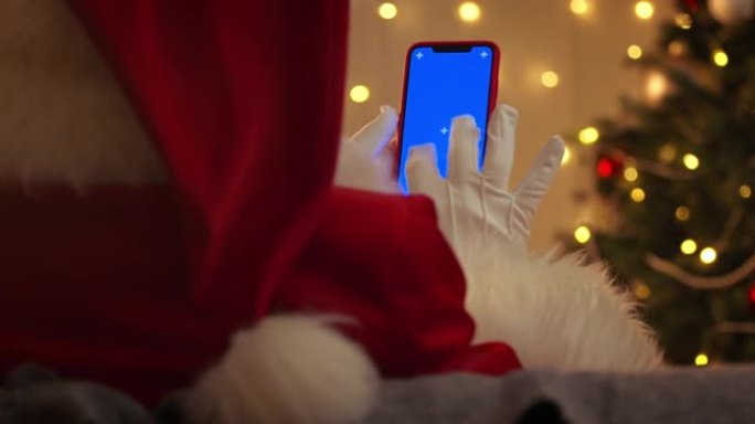 圣诞老人用蓝色色度键在智能手机上打字